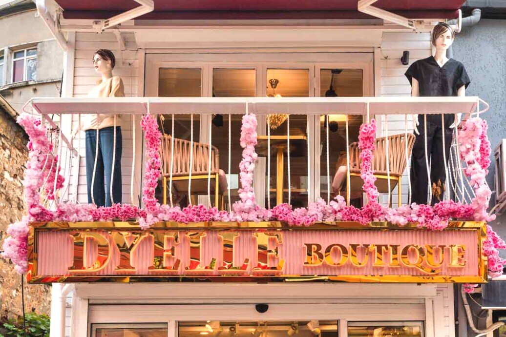 Una boutique con due manichini su un balcone.