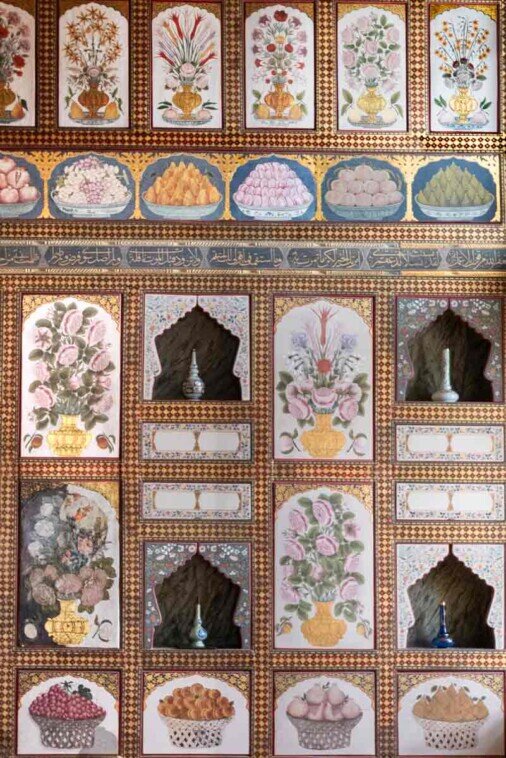 Dettagli ravvicinati di una parete della camera privata di Ahmed III con i colori dei vasi di fiori e contenitori di frutta variopinta.